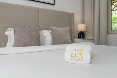 a white bed with a pillow on top at Cosy Palm Jumeirah 1 Bedroom - Perfect Location in Dubai