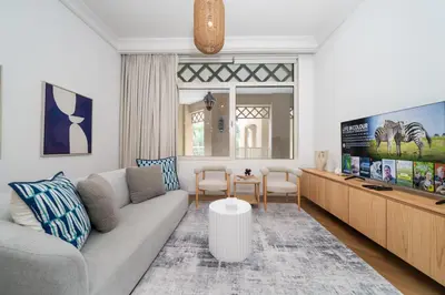 a living room with a couch and a tv at Cosy Palm Jumeirah 1 Bedroom - Perfect Location in Dubai
