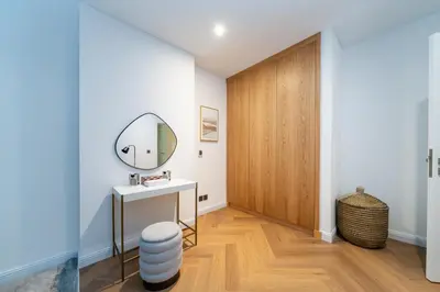 a bathroom with a mirror and a sink and a wooden door at Cosy Palm Jumeirah 1 Bedroom - Perfect Location in Dubai