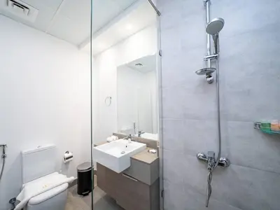 a bathroom with a toilet and a sink and a shower at Stylish Studio Living in the Heart of JVC in Dubai