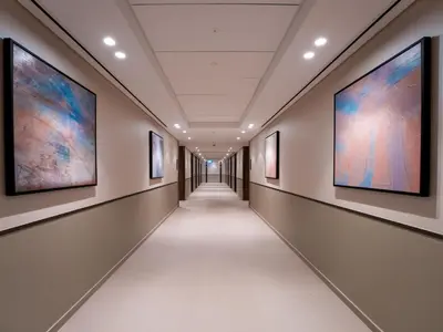 a corridor in a building with paintings on the walls at EasyGo-Core Luxury 2BDR in Grande Signature Res panoramic view in Dubai