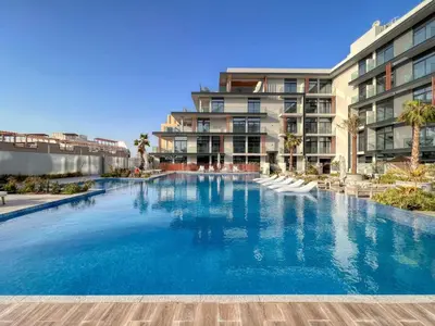 a large swimming pool in front of some apartment buildings at GuestReady - Glamorous retreat in JVC in Dubai