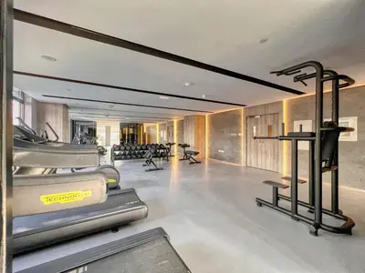 a gym with rows of exercise equipment in a building at GuestReady - Glamorous retreat in JVC in Dubai