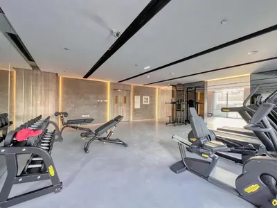 a gym with several treadmills and exercise bikes at GuestReady - Glamorous retreat in JVC in Dubai