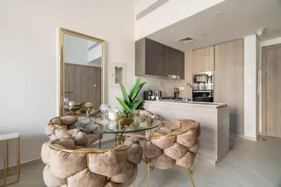 a kitchen with a glass table and some chairs at GuestReady - Glamorous retreat in JVC in Dubai
