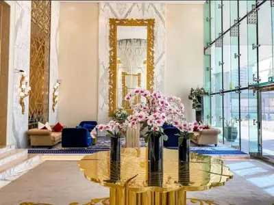 a lobby with a glass table with flowers on it at Luxurious studio in Damac maison prive by Phineek vacation home in Dubai