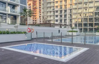 a swimming pool in the middle of a building at Elite LUX Holiday Homes - Upscale Studio in Azizi Riviera Prime Location Dubai in Dubai