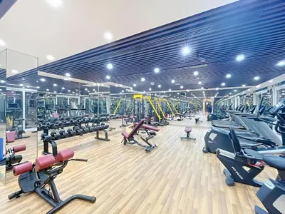 a gym with a large room filled with exercise equipment at Vacay Lettings - Pearlz By Danube -Studio-Al Furjan-Near Metro in Dubai