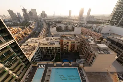 an aerial view of a city with tall buildings at Cozy 1BR with balcony in Binghatti Emerald in Dubai