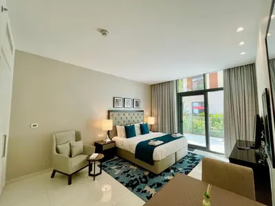 a hotel room with a bed and a chair at Vacay Lettings - Modern Studio Near to Expo City in Dubai