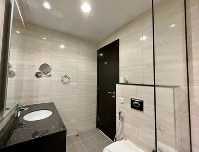 a bathroom with a sink and a shower at Vacay Lettings - Modern Studio Near to Expo City in Dubai