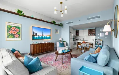 a living room with two couches and a dining room at Front Row Burj Khalifa Views - Dubai Mall Access - Premium 2BDR in Dubai