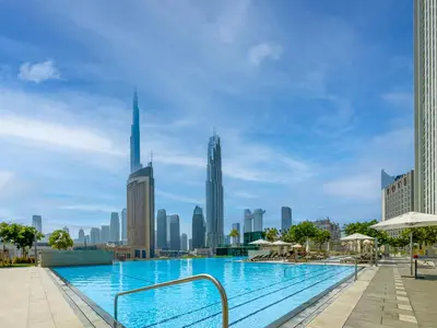 a swimming pool with a city skyline in the background at Front Row Burj Khalifa Views - Dubai Mall Access - Premium 2BDR in Dubai