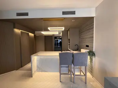 a kitchen with two bar stools and a counter top at Dubai Gate 1 in Dubai