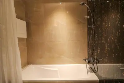 a bathroom with a shower with a bath tub at Luxurious Elite Studio-DownTown in Dubai