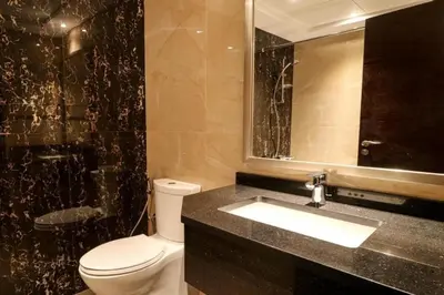 a bathroom with a toilet and a sink and a mirror at Luxurious Elite Studio-DownTown in Dubai