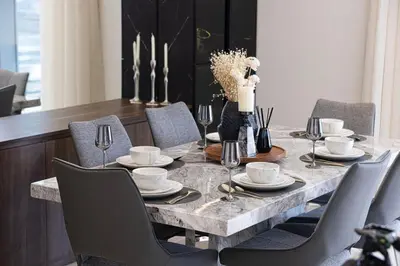 a dining room with a table with chairs and a dining room table at Modern Stylish 2 Bedroom Apartment with Burj Khalifa View in Dubai