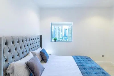 a bedroom with a large bed and a window at Dubai Gate 1 in Dubai