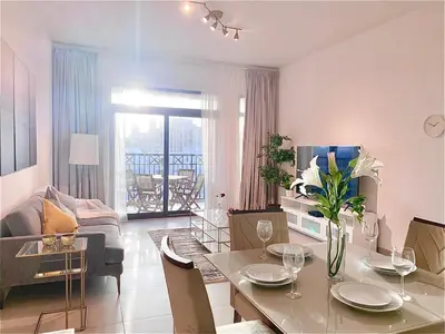 a living room with a table and a living room with a couch at 1 Bedroom Apartment with Burj AlArab View from your Balcony R507 in Dubai