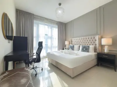 a bedroom with a bed and a desk and a computer at Stylish 2 Bedroom Opera View in Downtown Dubai SP2013 in Dubai