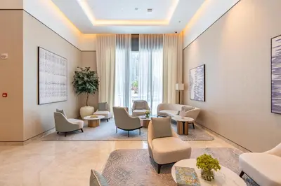 a waiting room with chairs and tables at BLVD - Steps from Dubai mall and Dancing Fountain in Dubai