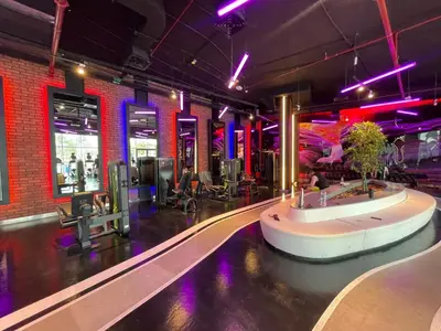 a fitness room with a pool and a gym at Studio apartment in jumeriah village triangle district 2 in Dubai