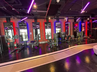 a gym with rows of chairs and a pool at Studio apartment in jumeriah village triangle district 2 in Dubai