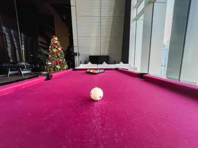 a pool table with a christmas tree in the background at Stunning Burj Khalifa & Downtown Views - Elegant 1BR in The Iconic Index Tower in Dubai