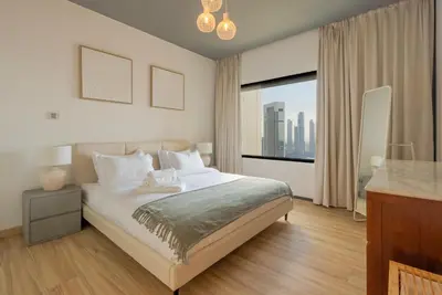 a bedroom with a large bed and a large window at Stunning Burj Khalifa & Downtown Views - Elegant 1BR in The Iconic Index Tower in Dubai