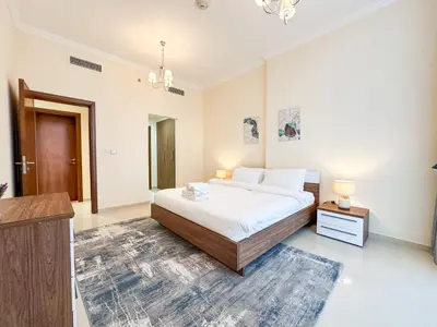 a bedroom with a large bed in a room at Elegant 1BR in Dunya Tower, Downtown Dubai 12AB10 in Dubai