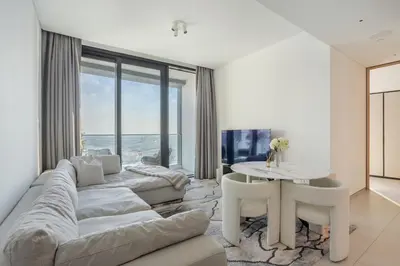 a living room with a couch and a table at Luxury Escape w Stunning Views Address JBR 1BR in Dubai