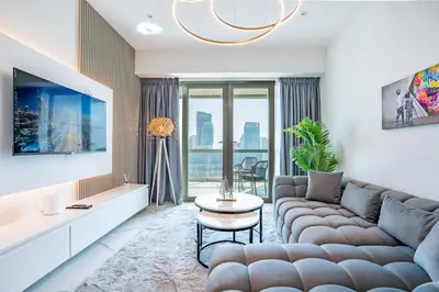 a living room with a couch and a table at RH -Luxury 1BR, Large Balcony & High-End Interiors, Downtown in Dubai