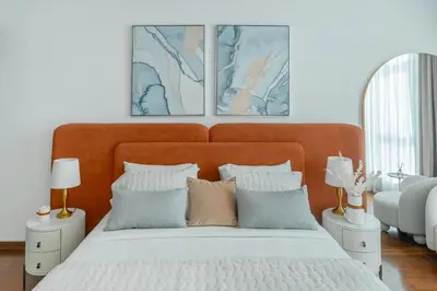a bedroom with a large bed with two pictures on the wall at Clever Guest 028 Baltic in Dubai