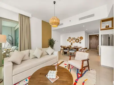 a living room with a couch and a table at Amazing view Burj Khalifa 5mn Dubai Mall 2BDR in Dubai