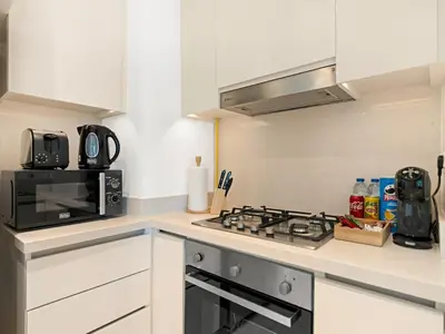 a kitchen with a stove and a microwave at Amazing view Burj Khalifa 5mn Dubai Mall 2BDR in Dubai