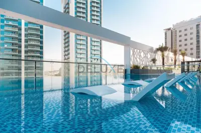 a swimming pool with a view of some tall buildings at Peaceful 1BR in Bella Rose Al Barsha South by Deluxe Holiday Homes in Dubai