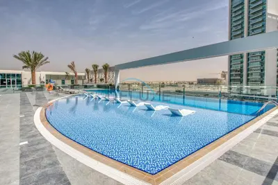 a swimming pool on the roof of a building at Peaceful 1BR in Bella Rose Al Barsha South by Deluxe Holiday Homes in Dubai