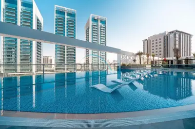 a swimming pool in a city with tall buildings at Peaceful 1BR in Bella Rose Al Barsha South by Deluxe Holiday Homes in Dubai