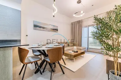 a dining room and living room with a table and chairs at Peaceful 1BR in Bella Rose Al Barsha South by Deluxe Holiday Homes in Dubai