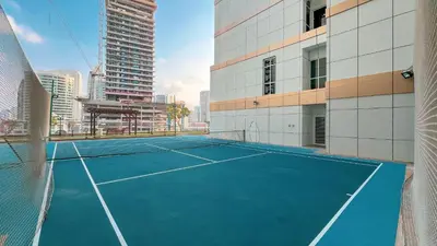 a tennis court in the middle of a city at 3BR Luxury Escape at Mon Reve I Access to Pool and Gym in Dubai