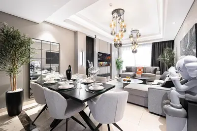 a dining room and living room with a table and chairs at 3BR Luxury Escape at Mon Reve I Access to Pool and Gym in Dubai