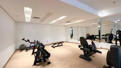 a gym with several exercise equipment in a room at 3BR Luxury Escape at Mon Reve I Access to Pool and Gym in Dubai