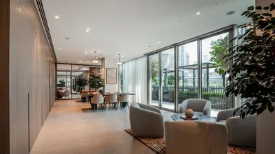 a lobby with chairs and a table and windows at Luxury 1-Bedroom Holiday Apartment in Downtown Dubai I Walk to Dubai Mall and Fountains in Dubai