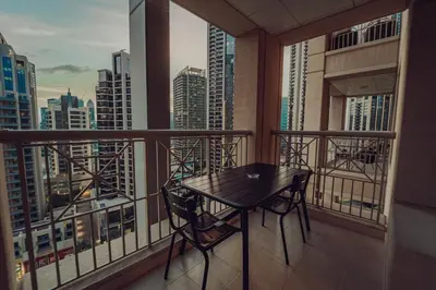 a balcony with a table and a view of a city at Elegant Studio Downtown 5 Minute Walk to Burj Khalifa & Dubai Mall in Dubai