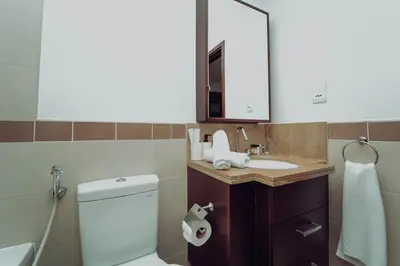a bathroom with a toilet and a sink and a mirror at Elegant Studio Downtown 5 Minute Walk to Burj Khalifa & Dubai Mall in Dubai