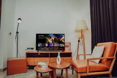 a living room with a tv and a couch and a chair at Elegant Studio Downtown 5 Minute Walk to Burj Khalifa & Dubai Mall in Dubai
