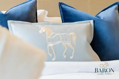 a pillow with a horse on it on a bed at The Classic in Dubai