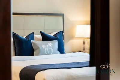 a bedroom with a bed with blue and white pillows at The Classic in Dubai