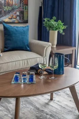 a coffee table with two glasses of wine on it at Frank Porter - Pulse C1 in Dubai