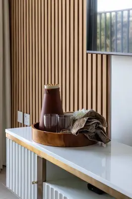 a wooden bowl on a table with bowls on it at Frank Porter - Golf Vile in Dubai